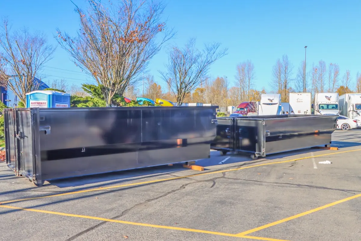 Professional dumpster rental service with roll-off container on residential driveway in Tequesta